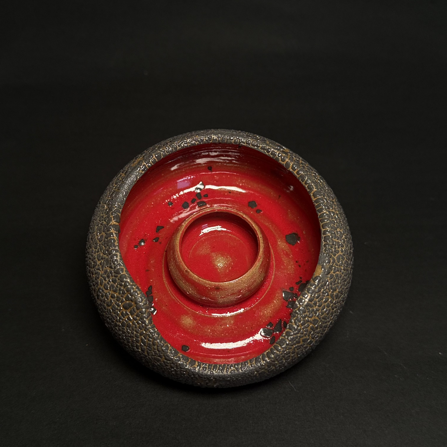 Elegant ashtray with sculptural curves in red and black – perfect for decorating coffee tables and celebrating dads & husbands with luxury.