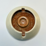Modern cream and brown ashtray with an artistic, sculptural form – a sophisticated accent for workspace styling and home décor vignettes.