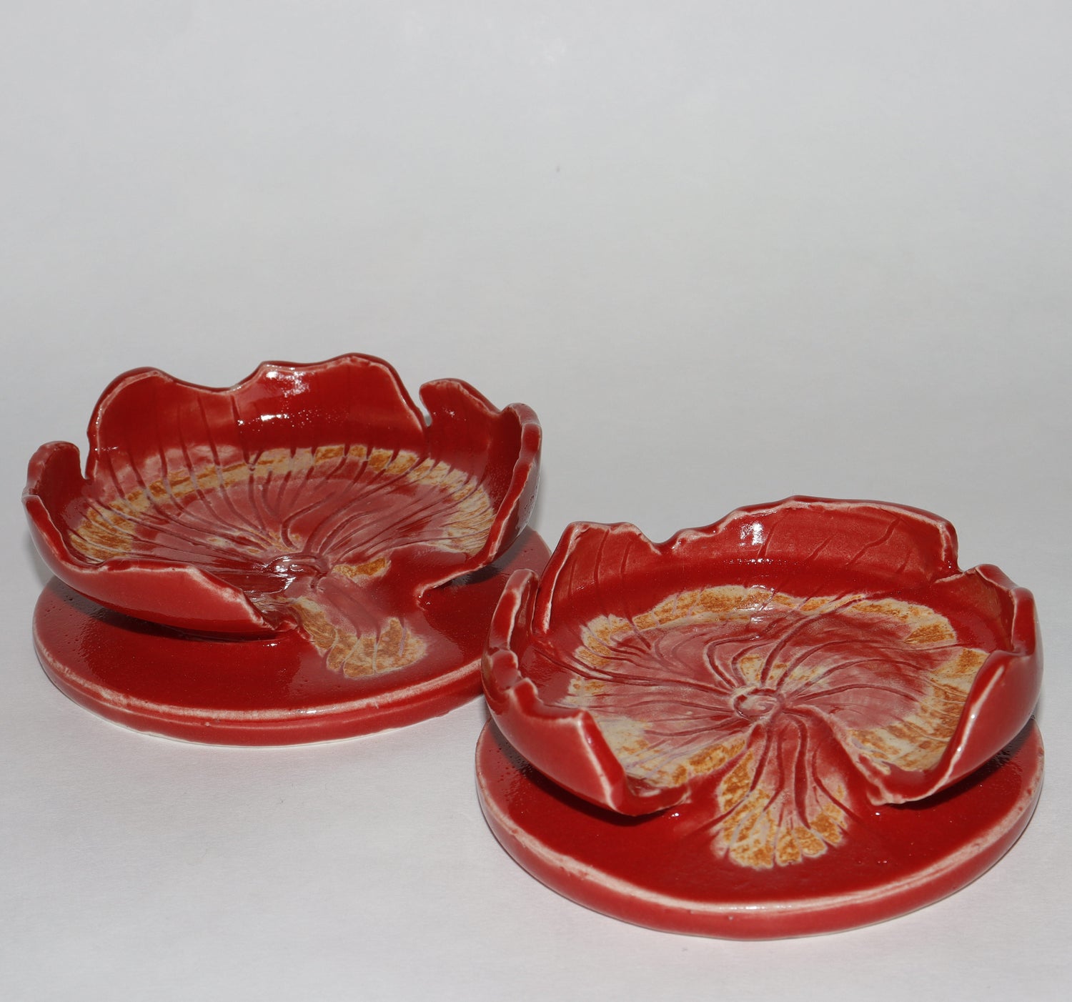 set of ceramic flower-shaped spoon rest on a white background